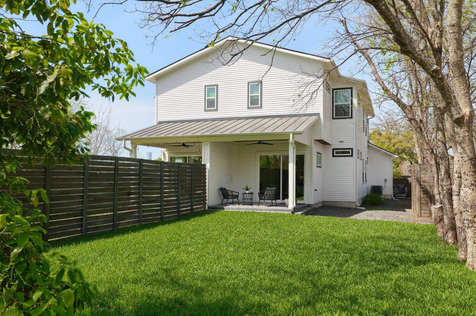 1103 Saucedo Street, Unit B Austin, TX 78721 - Photo 25 of 26 Shaded by established trees, this backyard provides a deep, green space that feels surprisingly private for being so close to the city center