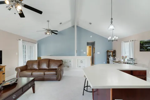a living room with furniture and a chandelier