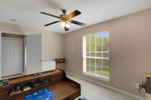 a room with windows and ceiling fan
