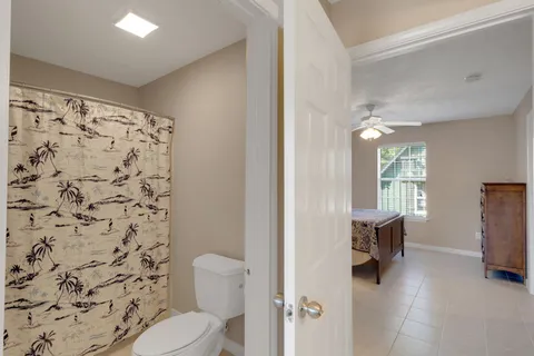 a bathroom with a toilet and a shower