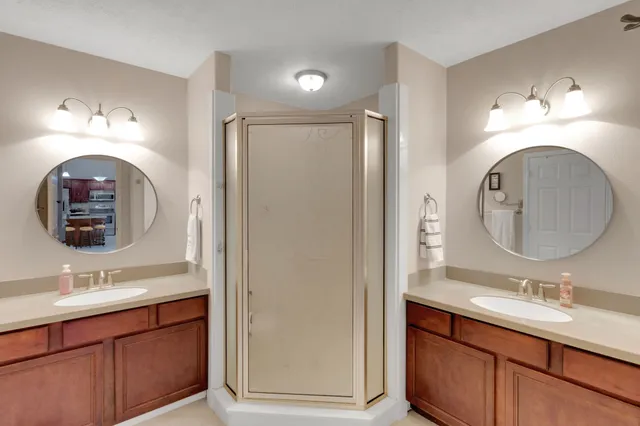 a bathroom with a double vanity sink and a mirror