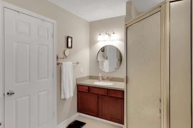 a bathroom with a sink a vanity and a mirror