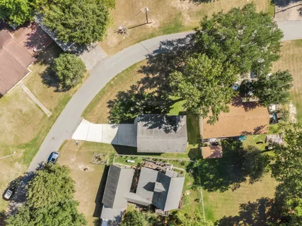 an aerial view of a house with a yard