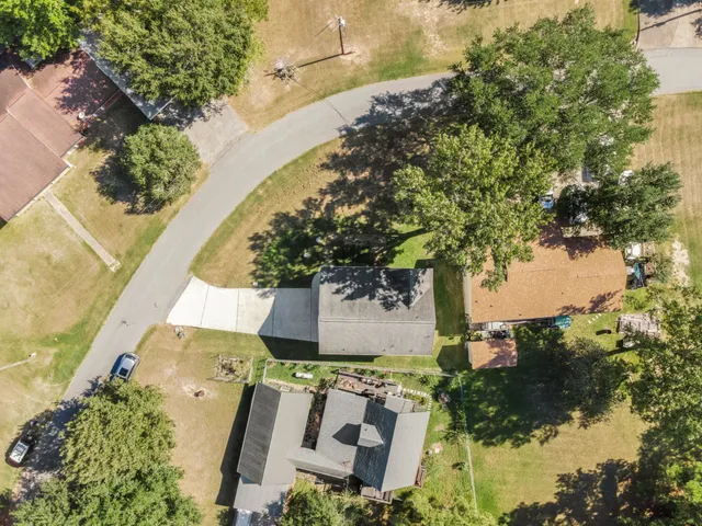 an aerial view of a house with a yard