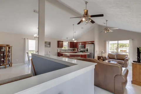 a living room with stainless steel appliances kitchen island granite countertop furniture and a kitchen view