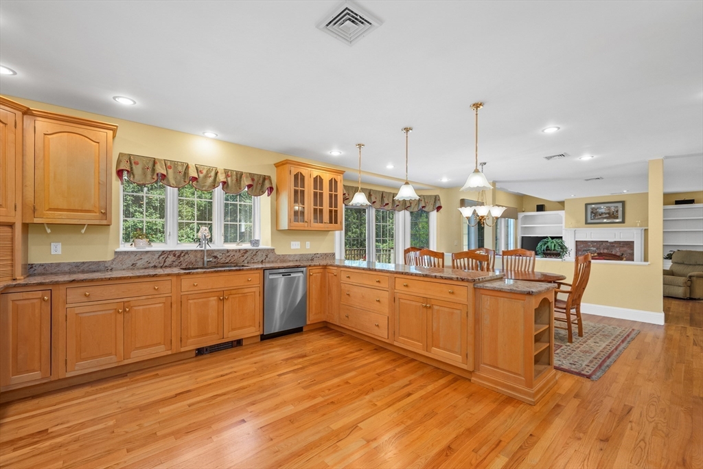 6 Match Point Dennis, MA 02638 - Photo 11 of 42 a large kitchen with stainless steel appliances kitchen island granite countertop a large window and cabinets