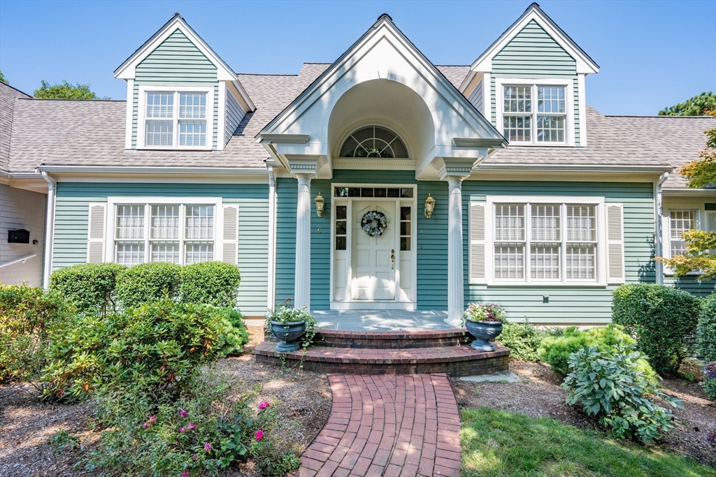 6 Match Point Dennis, MA 02638 - Photo 6 of 42 a front view of a house with garden