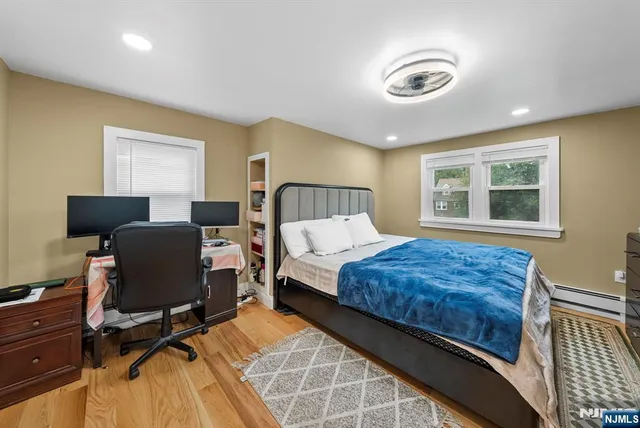 a bedroom with a bed and a large window