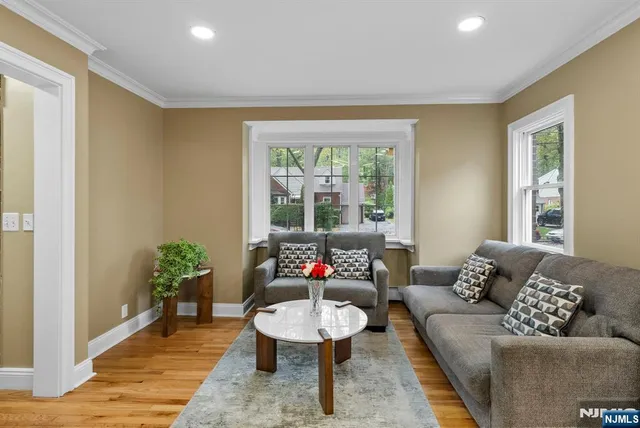 a kitchen with stainless steel appliances granite countertop a sink a stove a refrigerator cabinets and a window