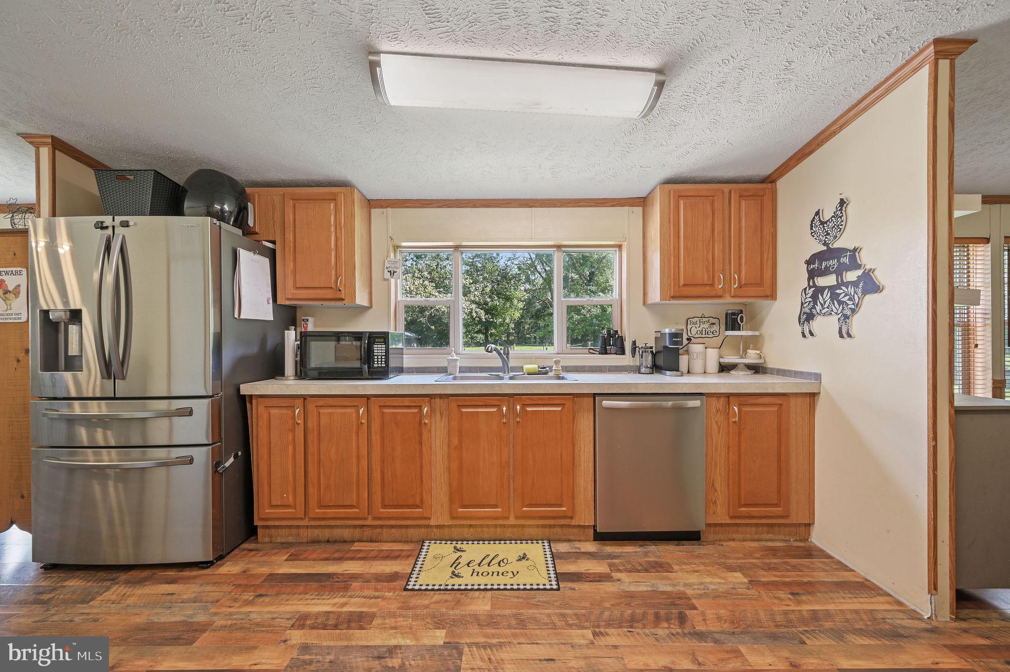 440 Indian Runner Road Felton, DE 19943 - Photo 22 of 50 a kitchen with stainless steel appliances a refrigerator sink and cabinets