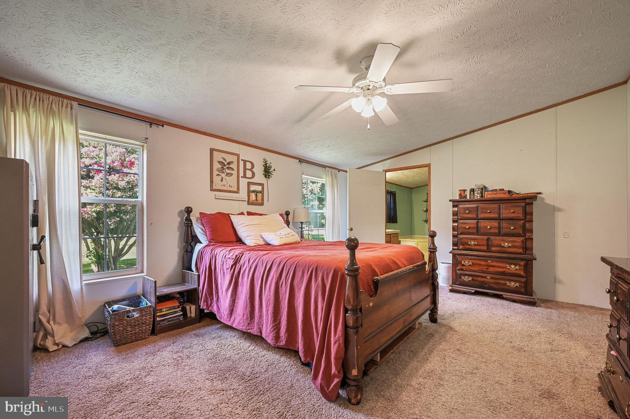 440 Indian Runner Road Felton, DE 19943 - Photo 30 of 50 a bed room with a bed and a chandelier