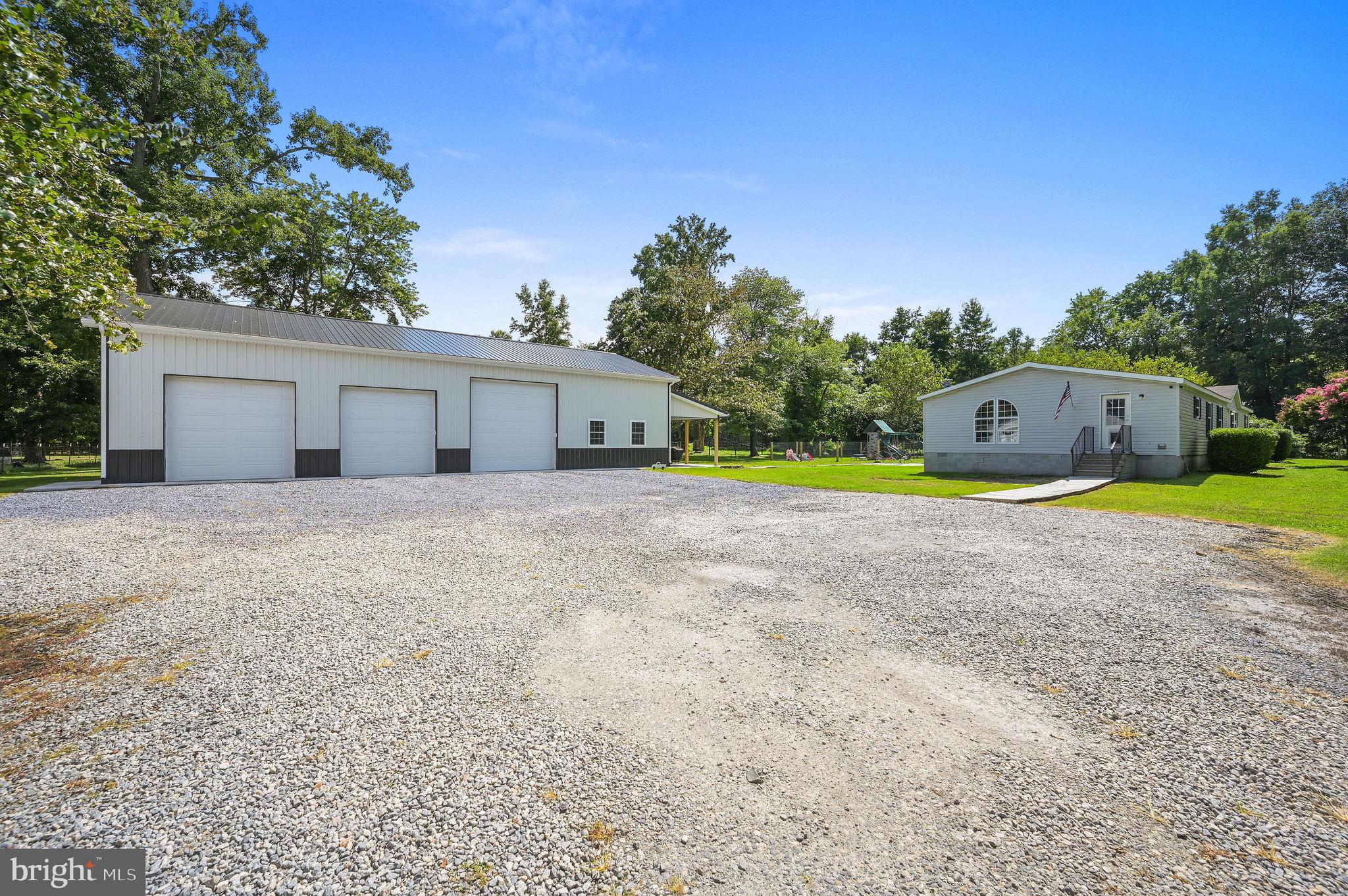 440 Indian Runner Road Felton, DE 19943 - Photo 3 of 50 a house with swimming pool in front of it