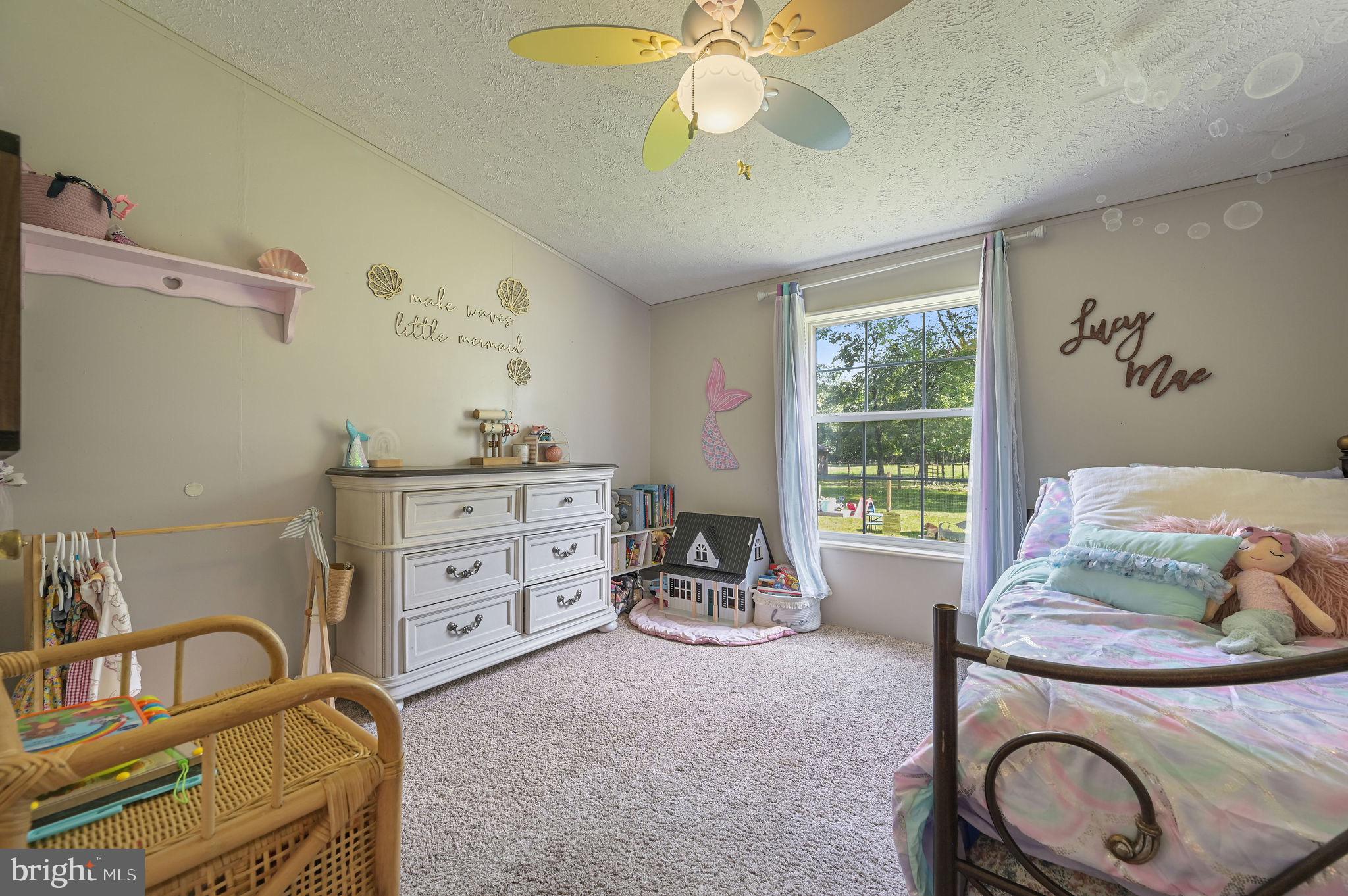 440 Indian Runner Road Felton, DE 19943 - Photo 32 of 50 a bedroom with a bed and a chandelier