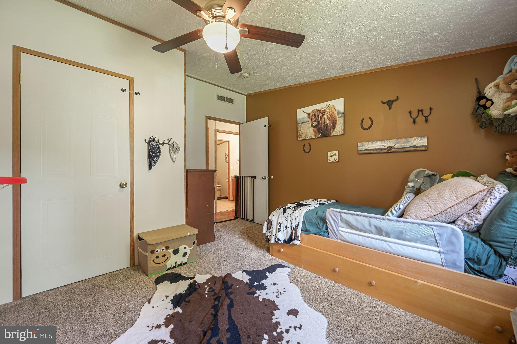 440 Indian Runner Road Felton, DE 19943 - Photo 36 of 50 a bedroom with a bed and a chandelier