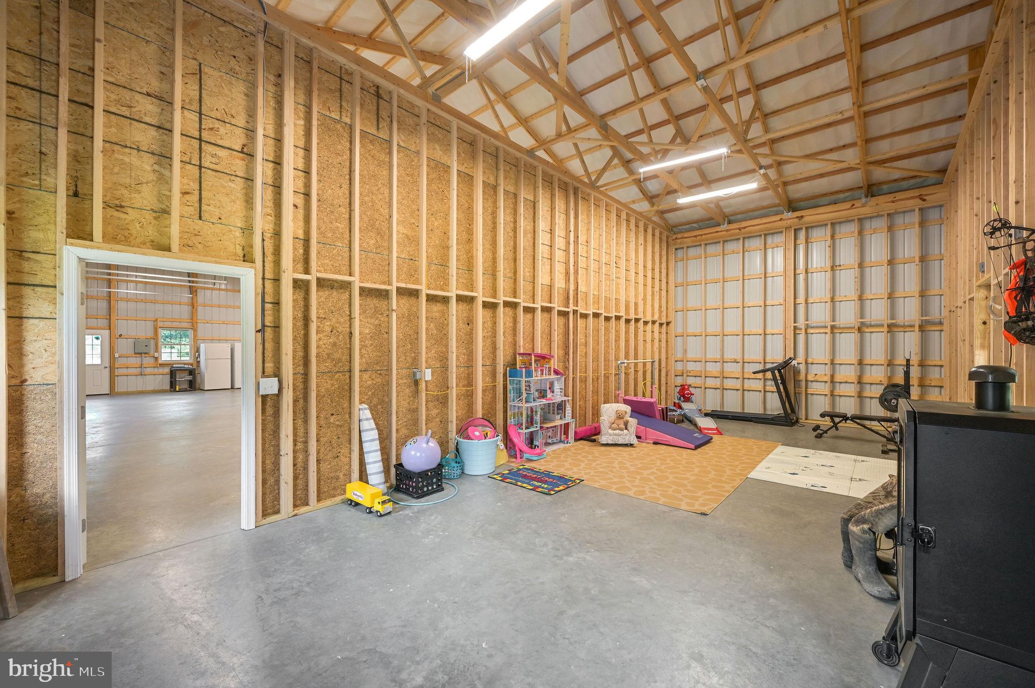 440 Indian Runner Road Felton, DE 19943 - Photo 6 of 50 a view of a room with gym equipment and large windows