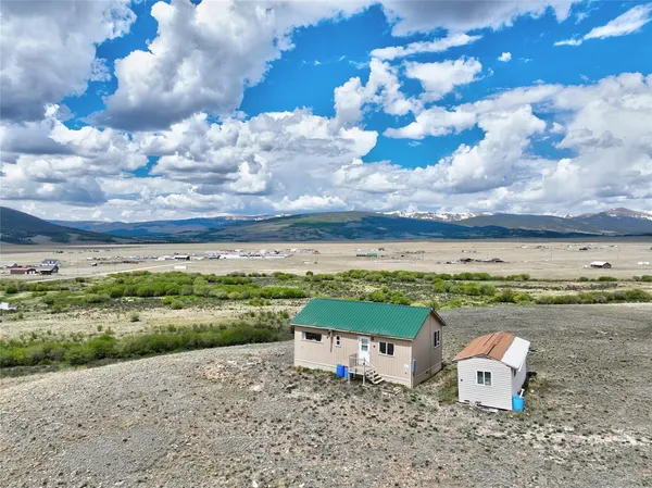 an aerial view of a house with a yard