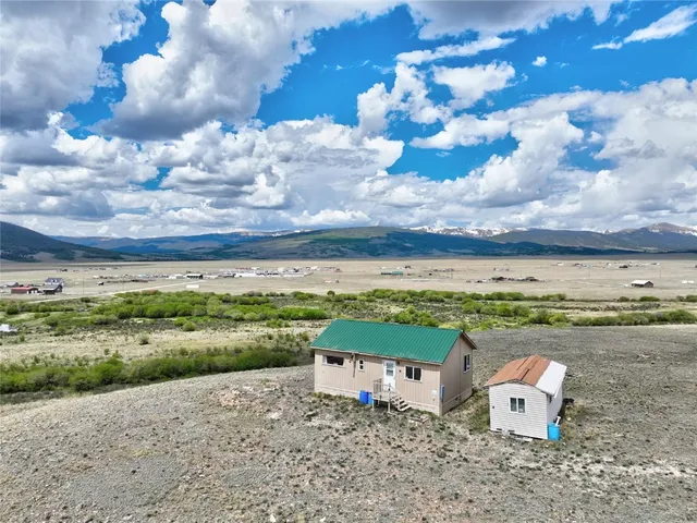 an aerial view of a house with a yard