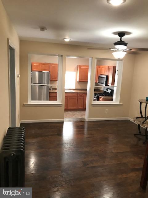 2011 Stenton Avenue, Unit A Philadelphia, PA 19138 - Photo 5 of 20 a view of an empty room with window and wooden floor
