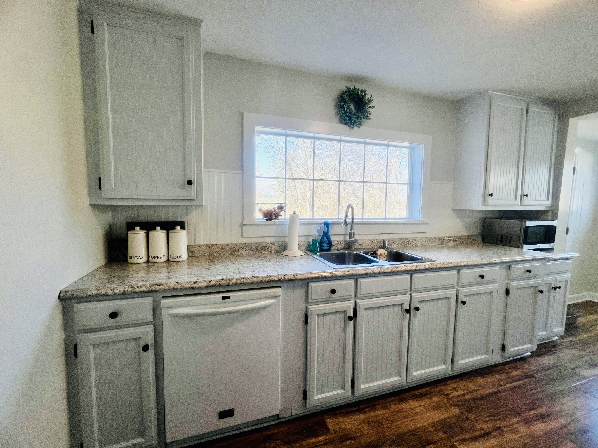 100 Locust Street Alexandria, TN 37012 - Photo 16 of 21 a kitchen with granite countertop white cabinets and white appliances