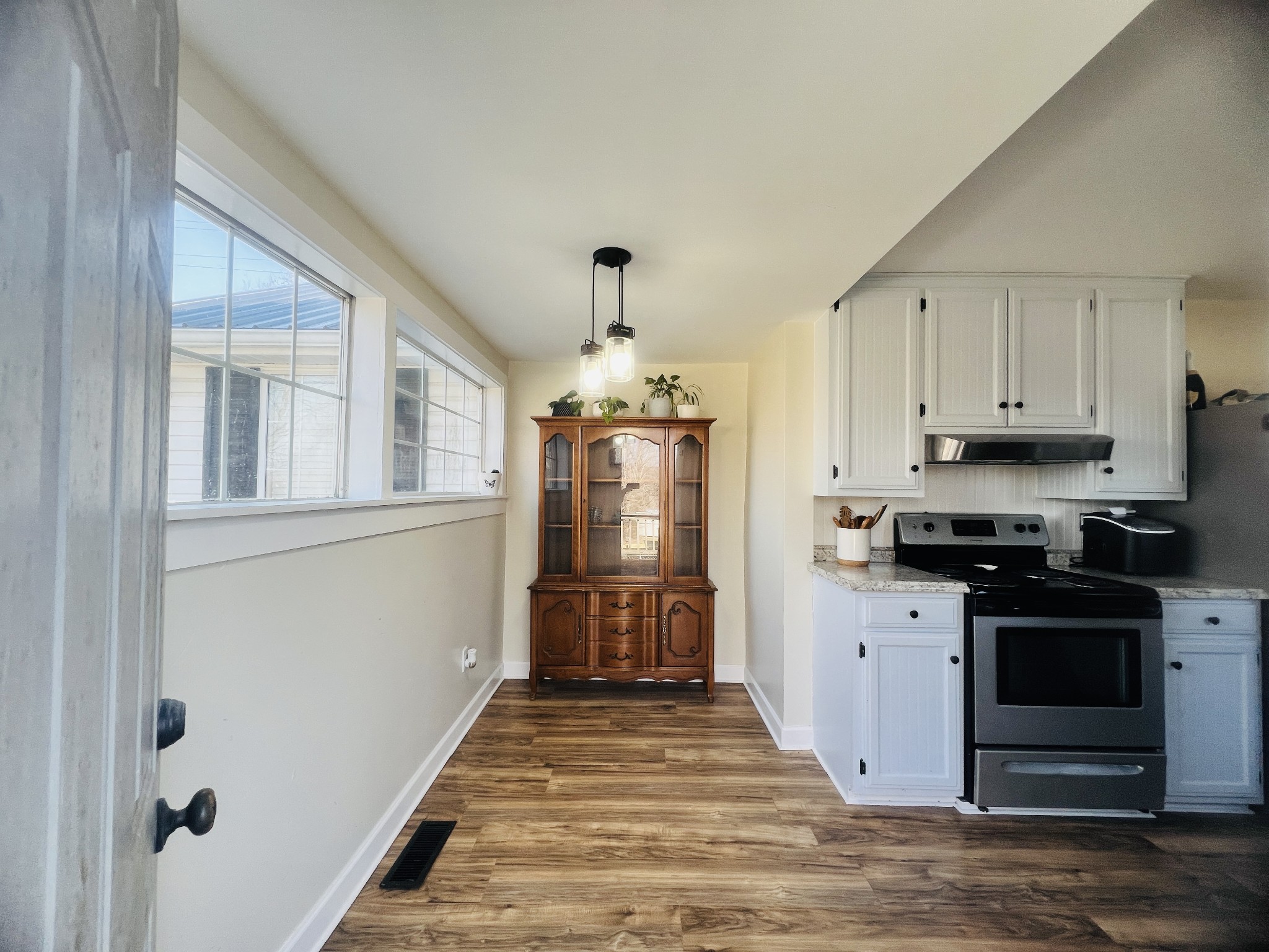 100 Locust Street Alexandria, TN 37012 - Photo 19 of 21 a kitchen with stainless steel appliances granite countertop a stove and a refrigerator