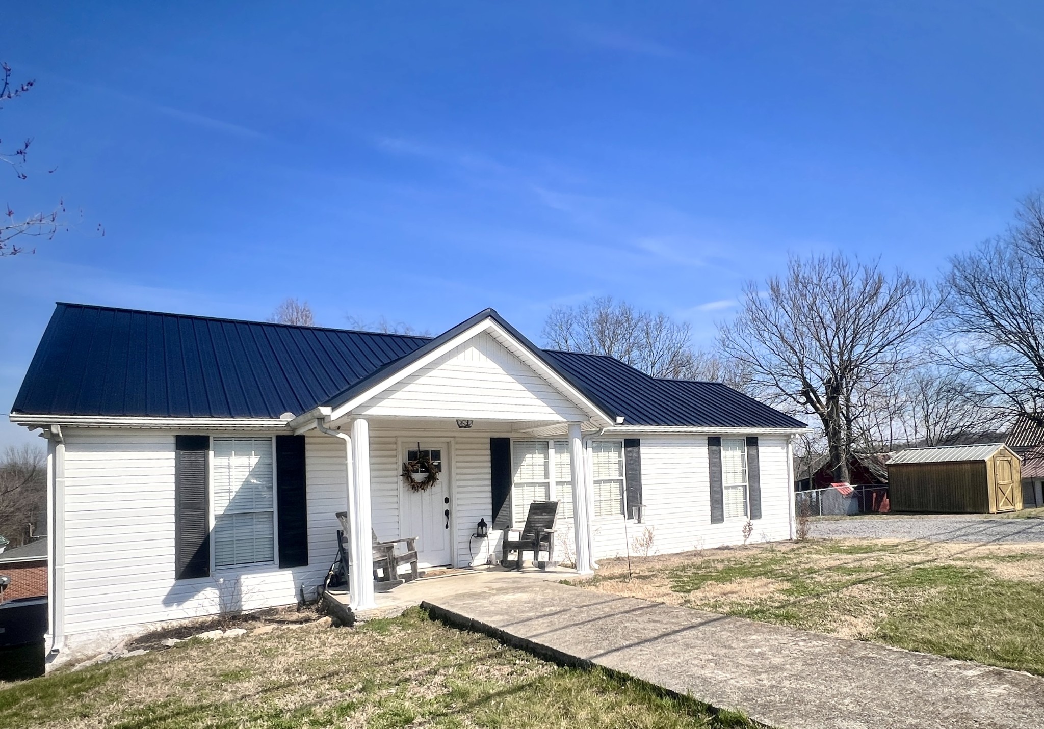 100 Locust Street Alexandria, TN 37012 - Photo 2 of 21 a front view of a house with a porch