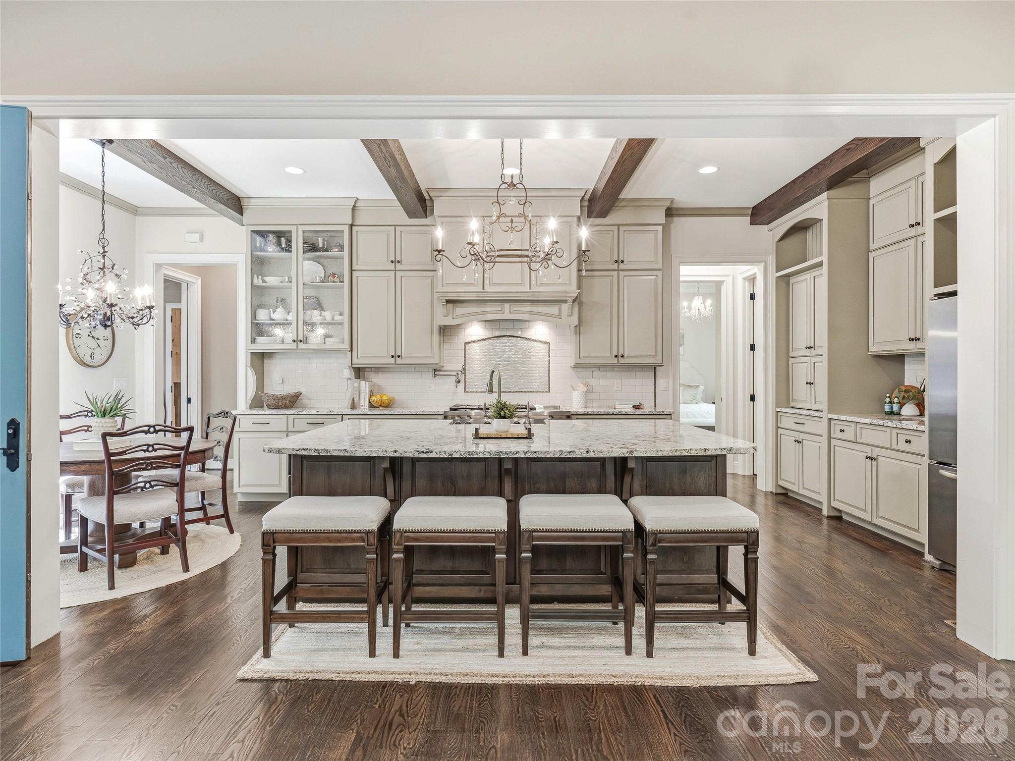 732 Streamside Drive Arden, NC 28704 - Photo 13 of 46 a dining room with granite countertop a table chairs and a kitchen view
