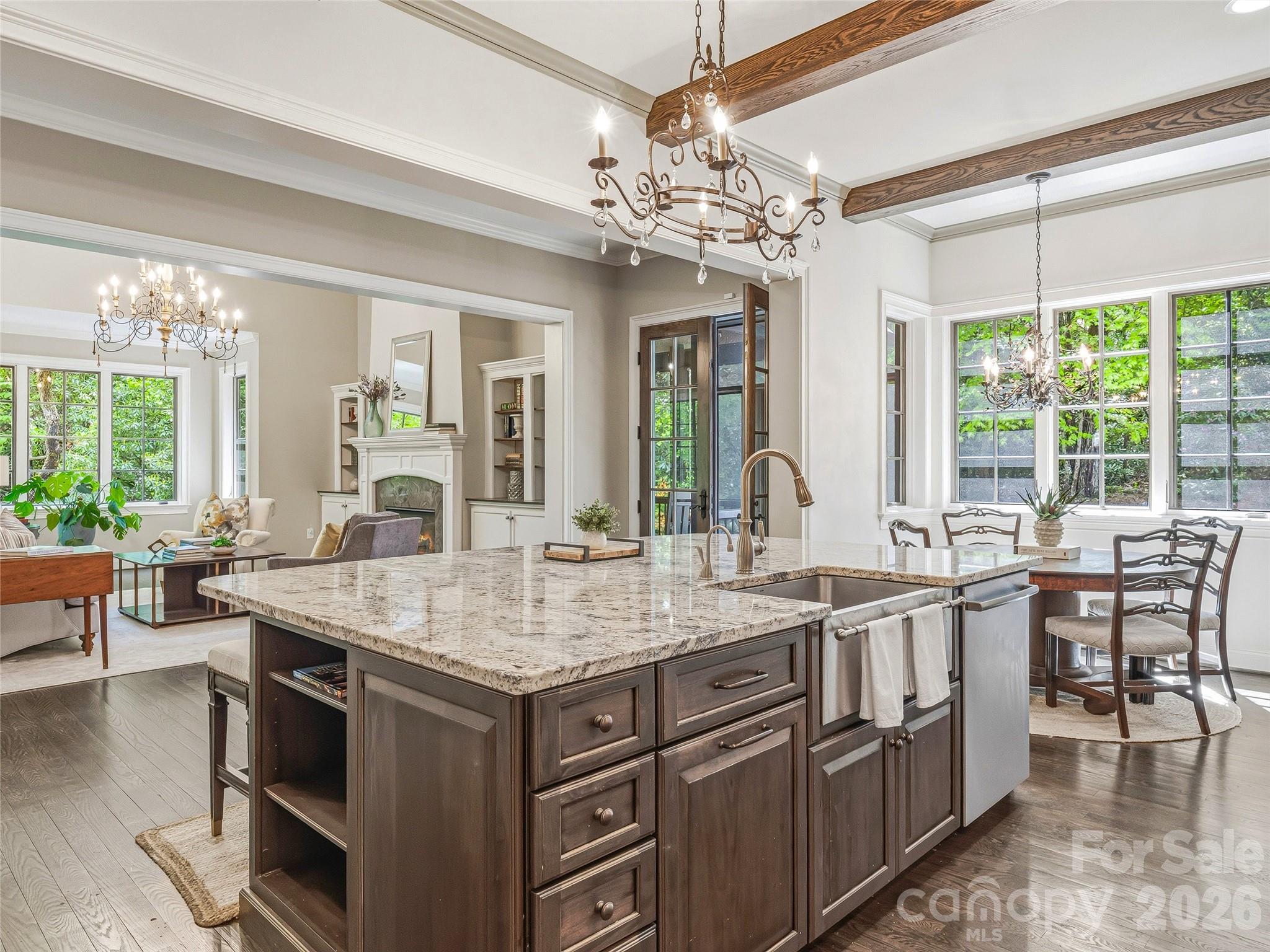 732 Streamside Drive Arden, NC 28704 - Photo 17 of 46 a room with kitchen island granite countertop a sink and chandelier