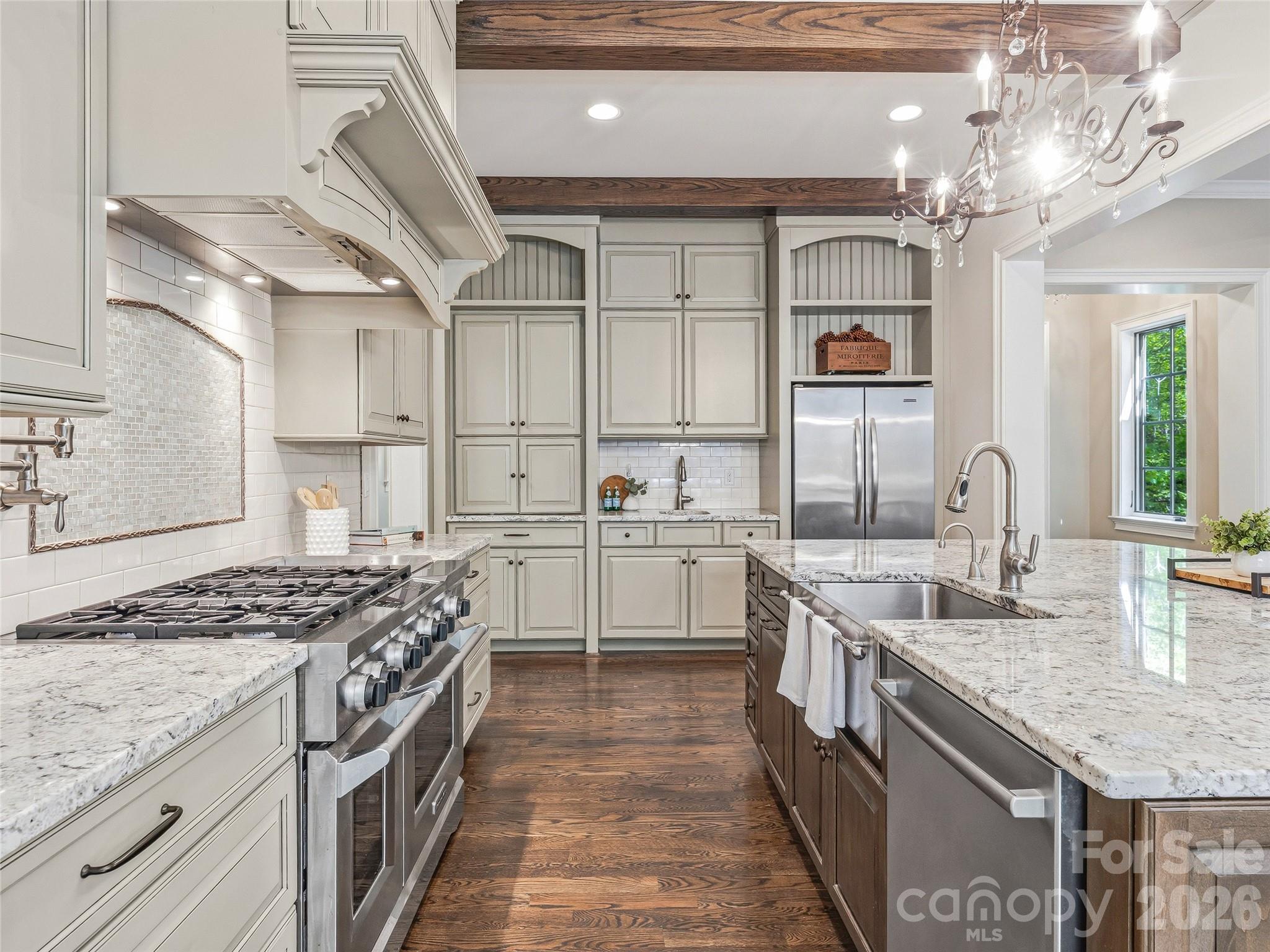 732 Streamside Drive Arden, NC 28704 - Photo 18 of 46 a kitchen with stainless steel appliances granite countertop a sink stove and cabinets