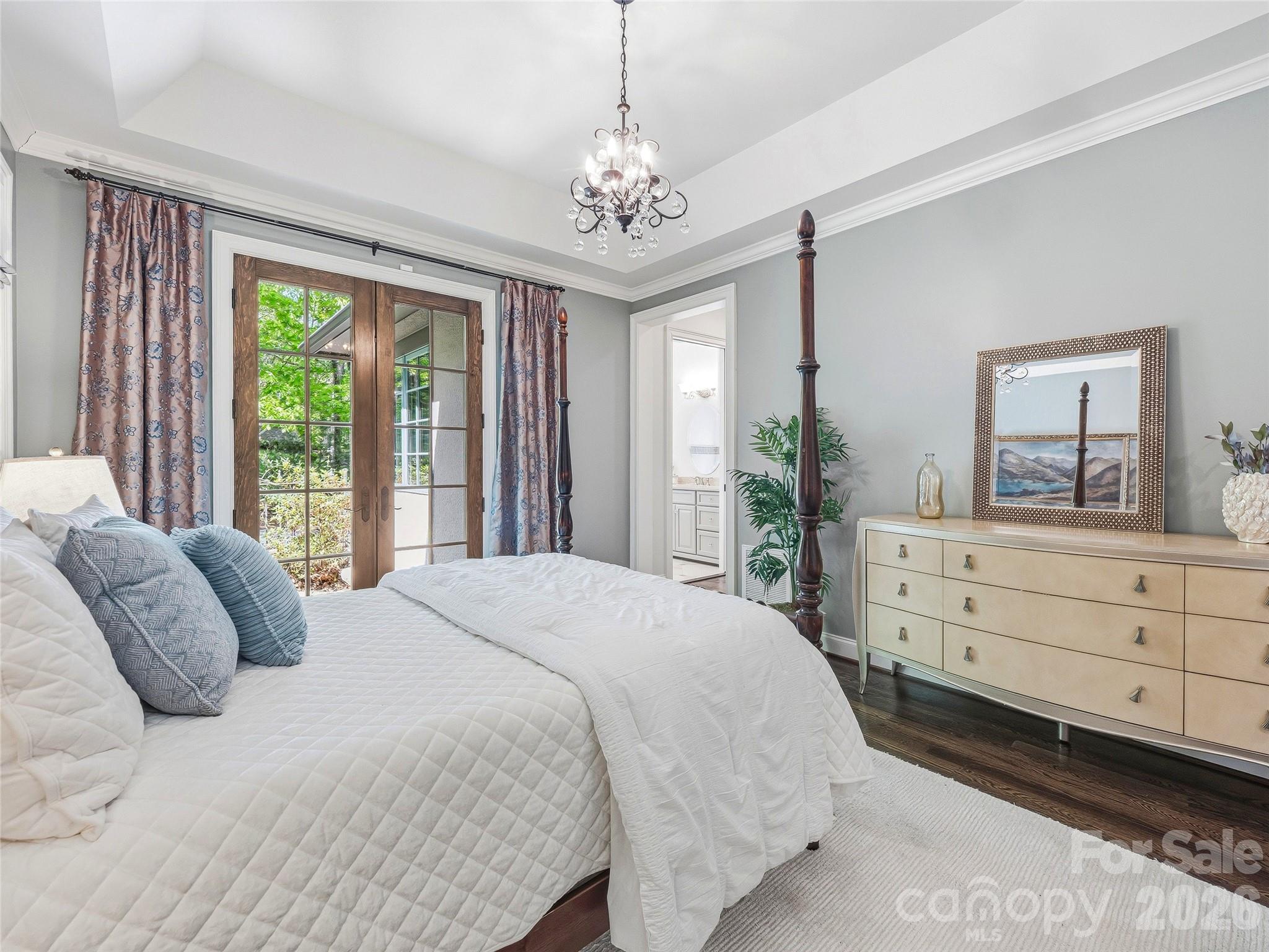 732 Streamside Drive Arden, NC 28704 - Photo 24 of 46 a spacious bedroom with a large bed and a dresser