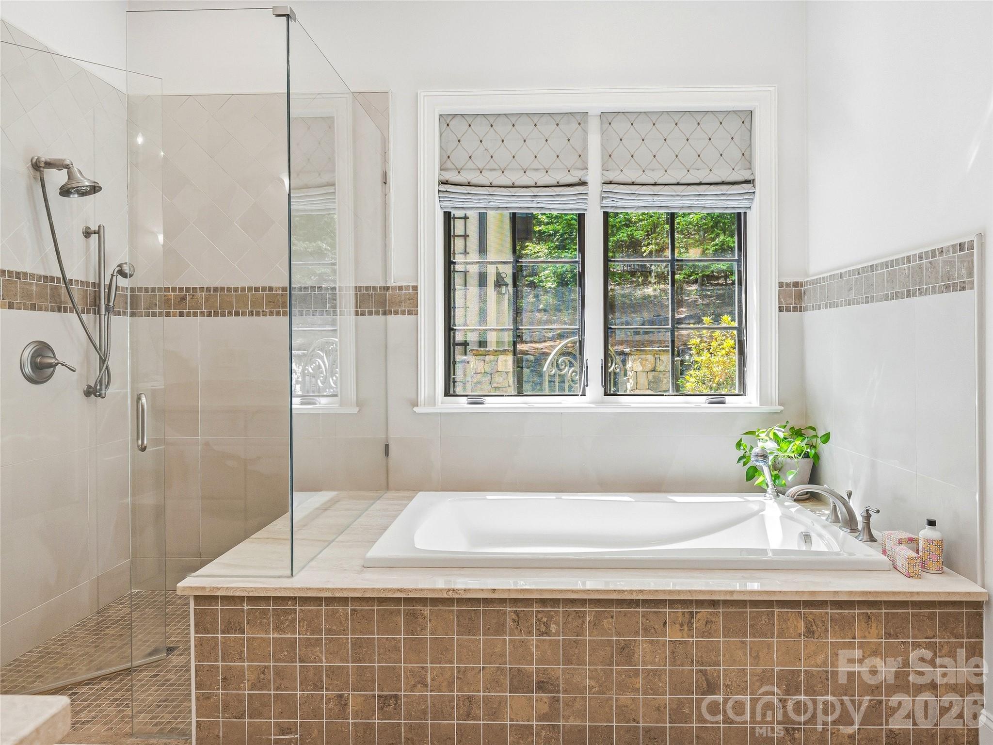 732 Streamside Drive Arden, NC 28704 - Photo 27 of 46 a bathroom with a bathtub and shower