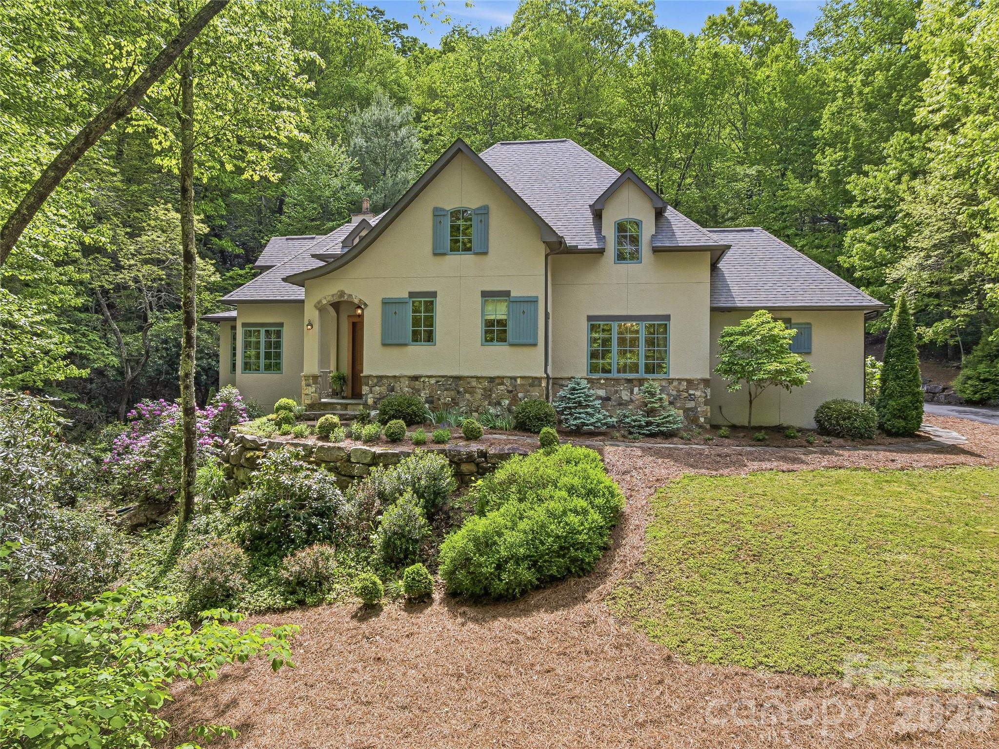 732 Streamside Drive Arden, NC 28704 - Photo 3 of 46 a front view of a house with garden