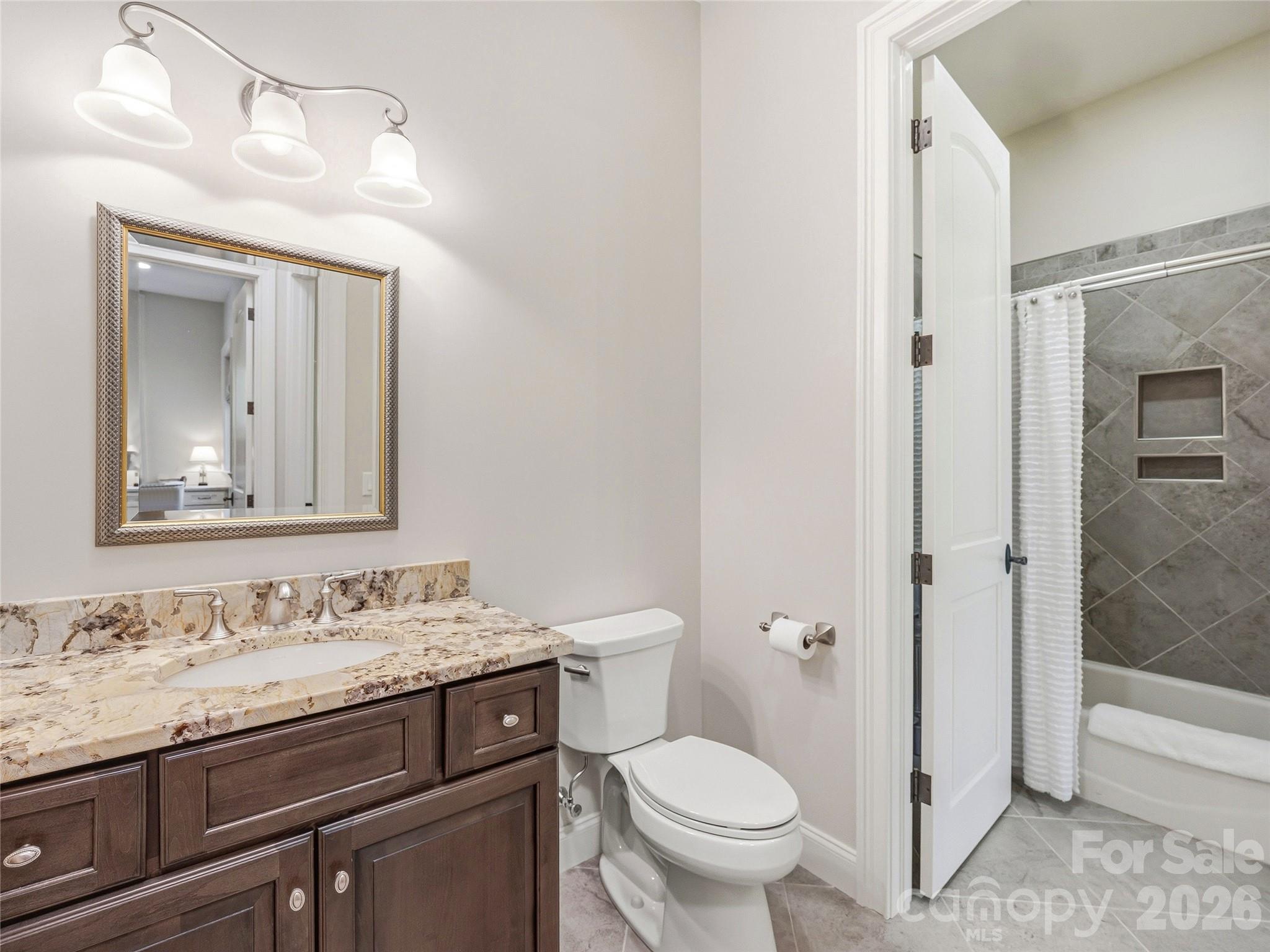 732 Streamside Drive Arden, NC 28704 - Photo 31 of 46 a bathroom with a granite countertop sink toilet and shower