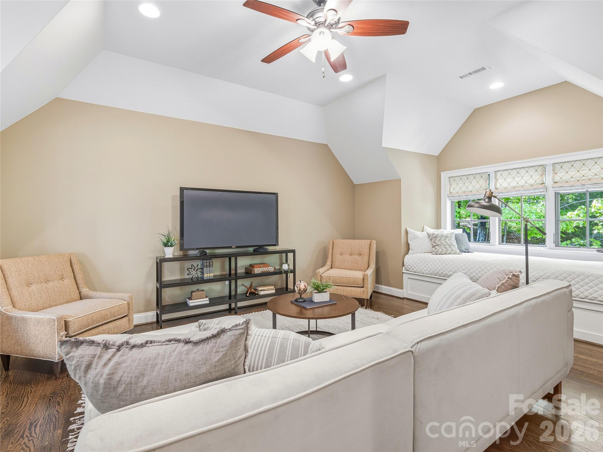 732 Streamside Drive Arden, NC 28704 - Photo 32 of 46 a living room with furniture and a flat screen tv