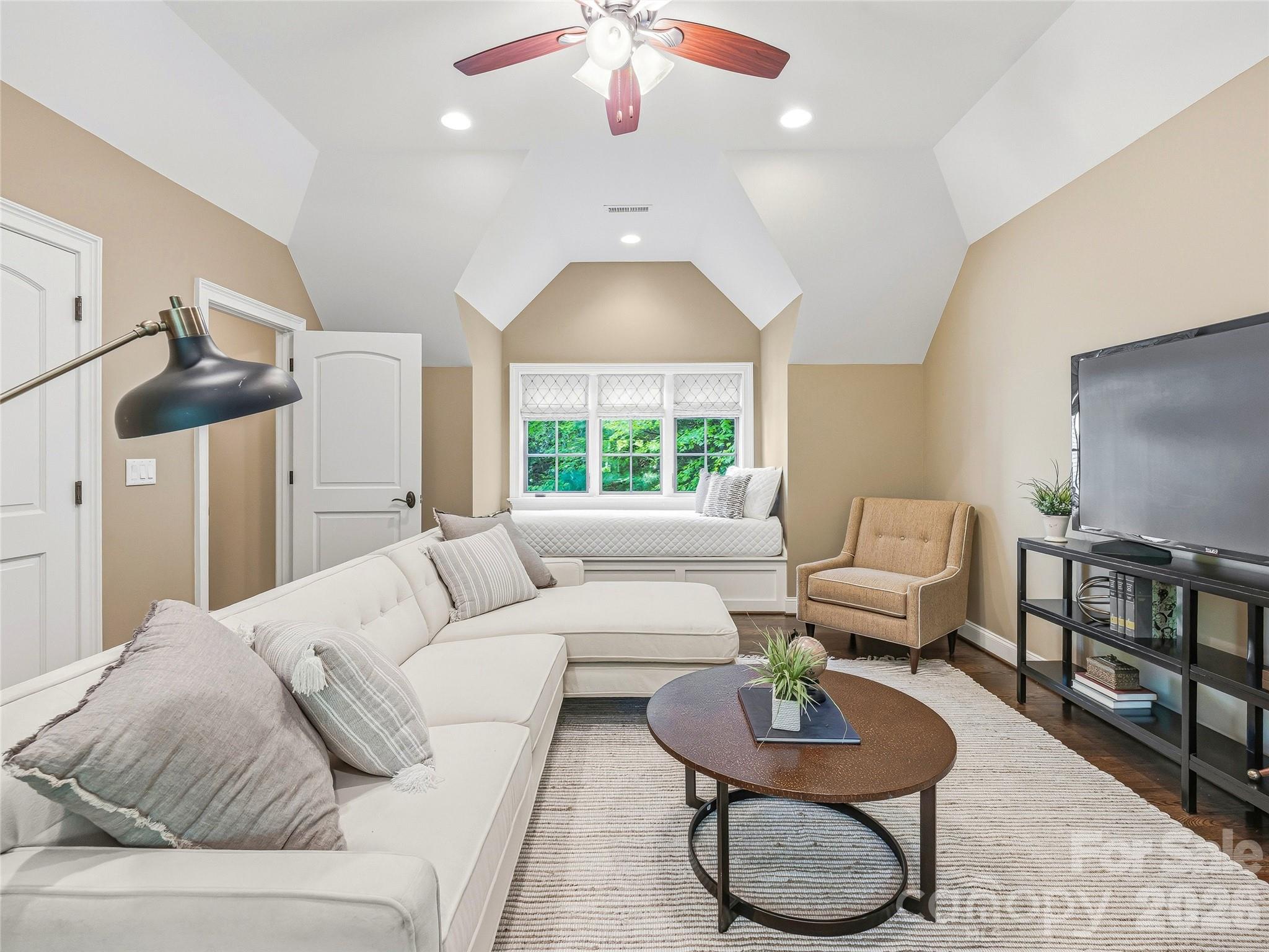 732 Streamside Drive Arden, NC 28704 - Photo 33 of 46 a living room with furniture a rug and a chandelier