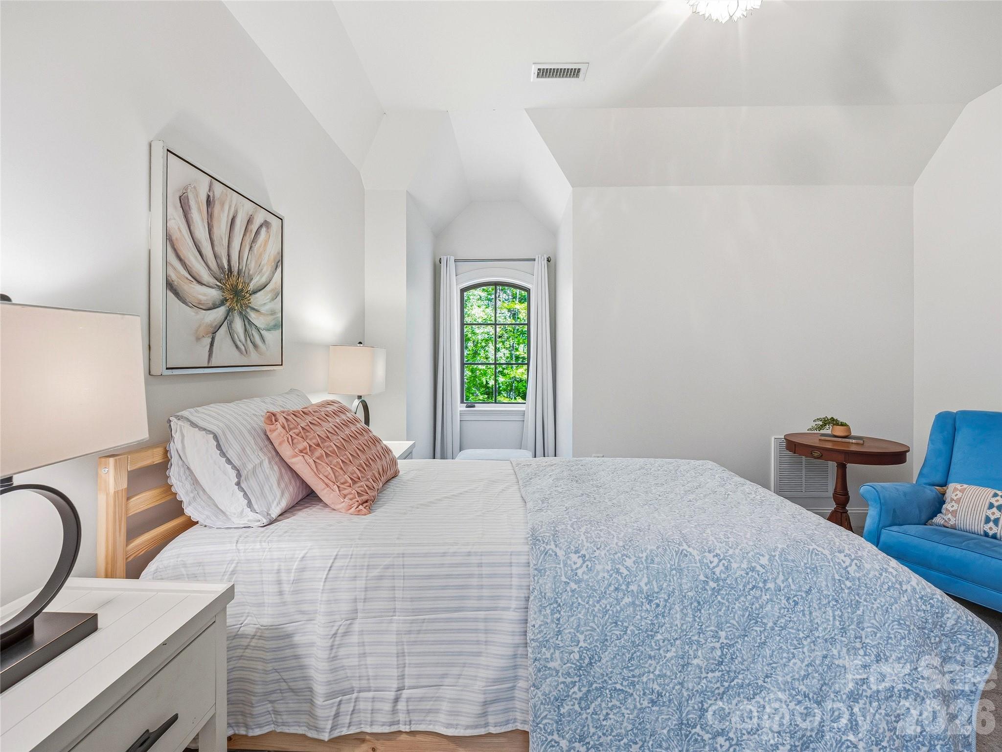 732 Streamside Drive Arden, NC 28704 - Photo 34 of 46 a bedroom with a bed and painting on the wall