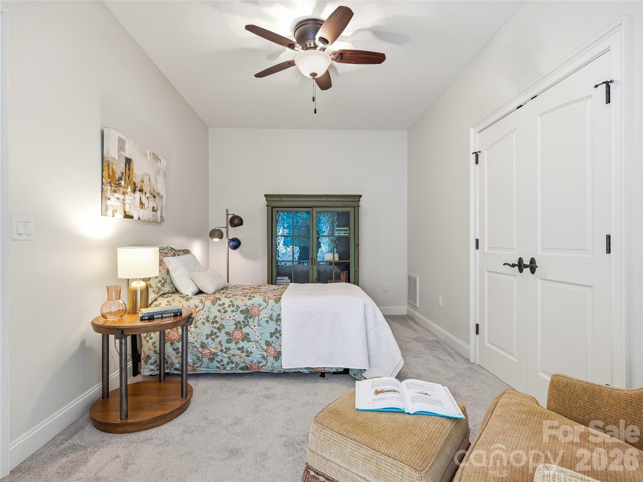 732 Streamside Drive Arden, NC 28704 - Photo 36 of 46 a bedroom with a bed and a chandelier