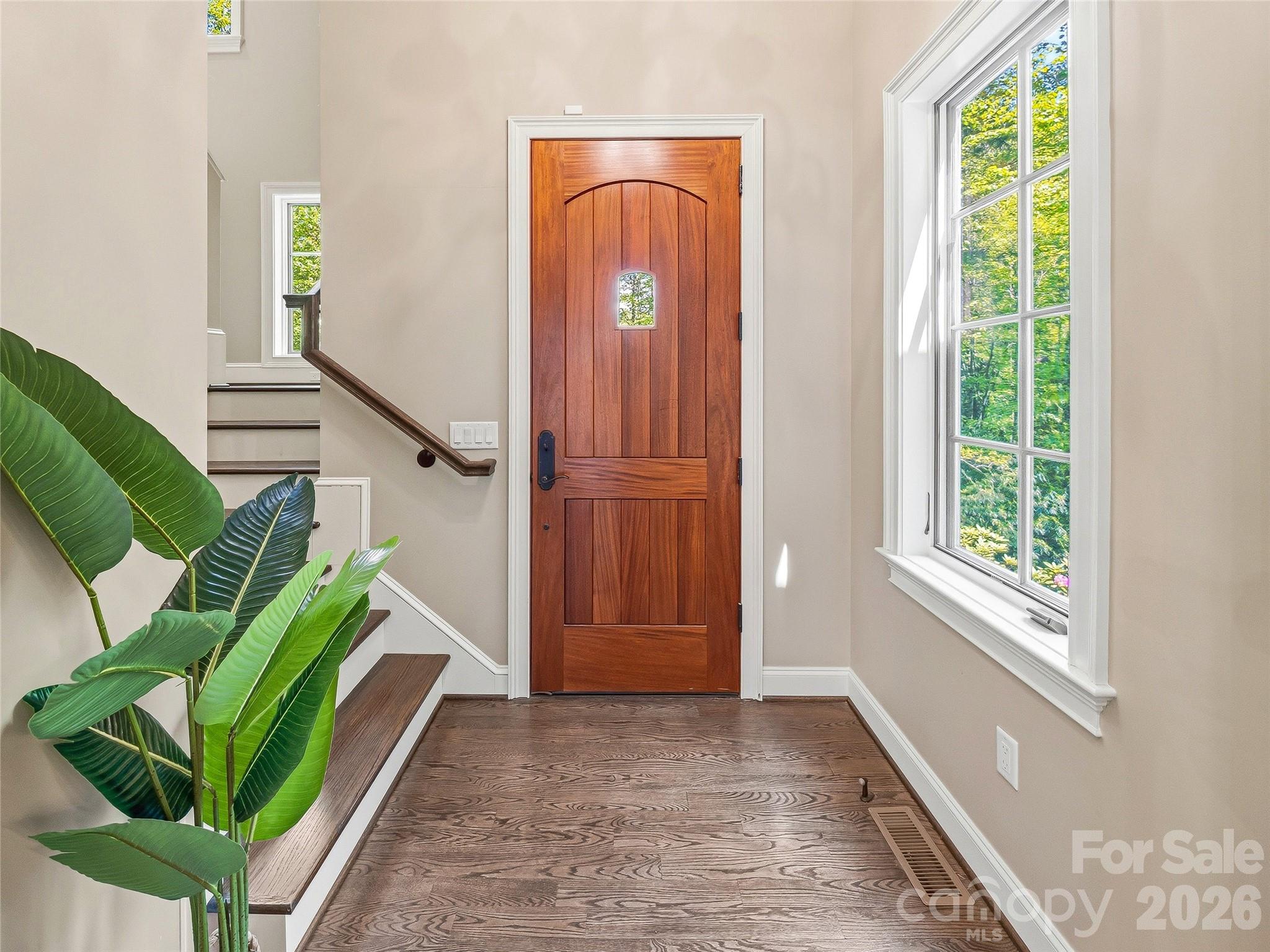 732 Streamside Drive Arden, NC 28704 - Photo 4 of 46 a view of entryway with stairs and a potted plant