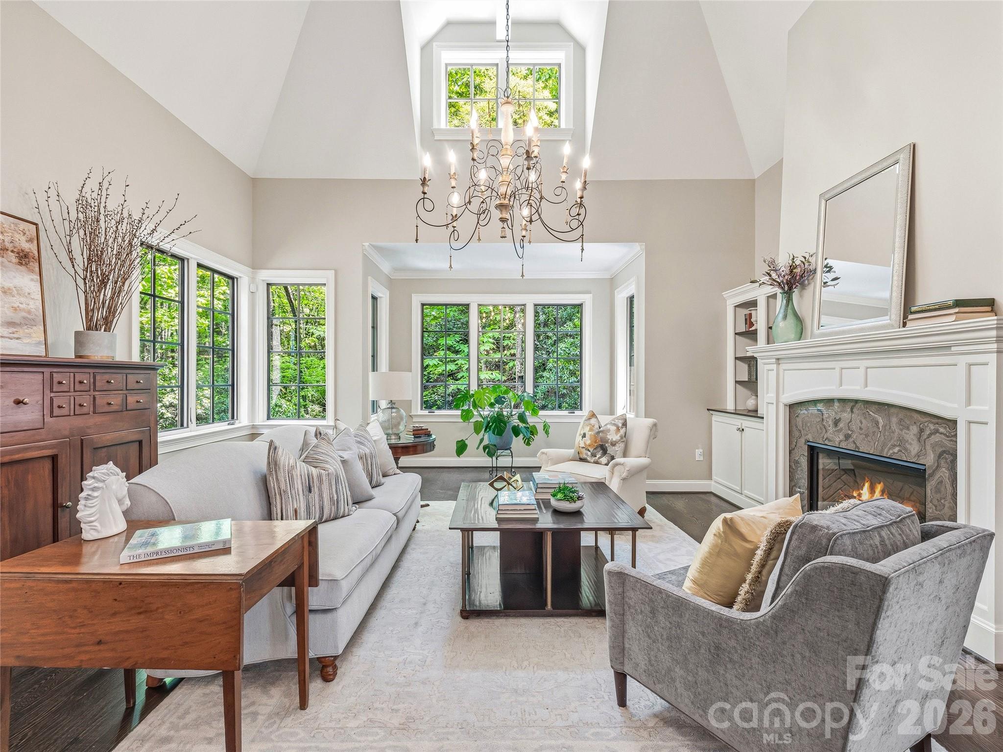 732 Streamside Drive Arden, NC 28704 - Photo 6 of 46 a living room with furniture fireplace and large windows