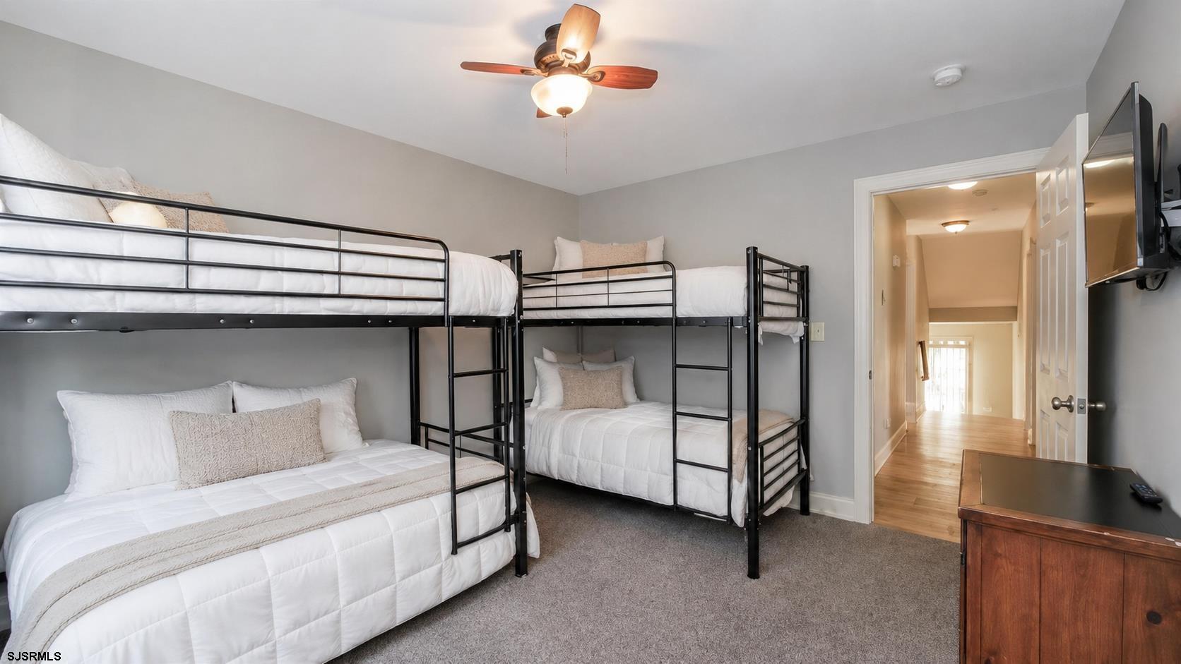 2070 West Riverside Drive Atlantic City, NJ 08401 - Photo 21 of 40 a bedroom with a bed and a flat tv screen on the dresser