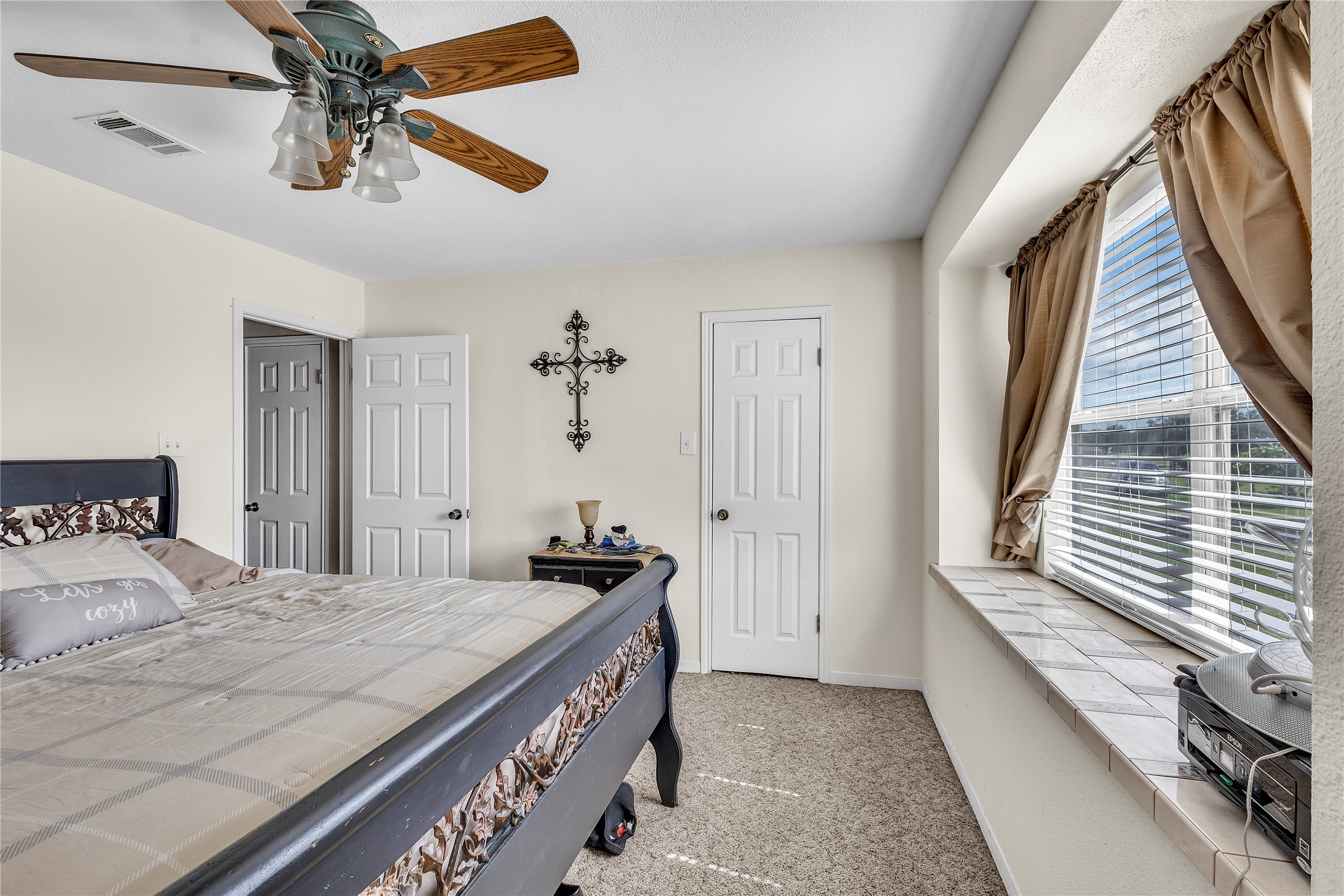 1080 League Line Road Paige, TX 78659 - Photo 20 of 39 Plentiful natural light filters through the deep window sill of this comfortable carpeted bedroom.