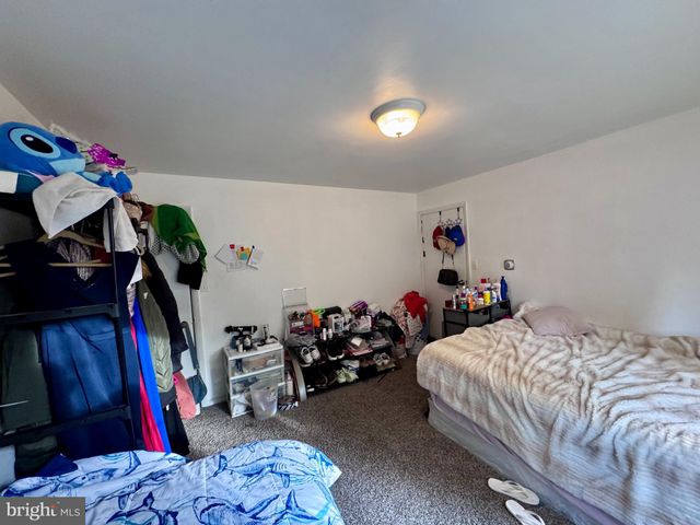 a bedroom with a bed closet and a mirror