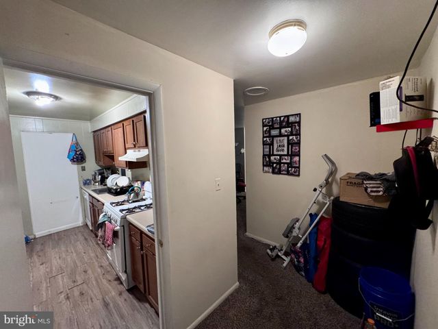 a view of a hallway with workspace and a window