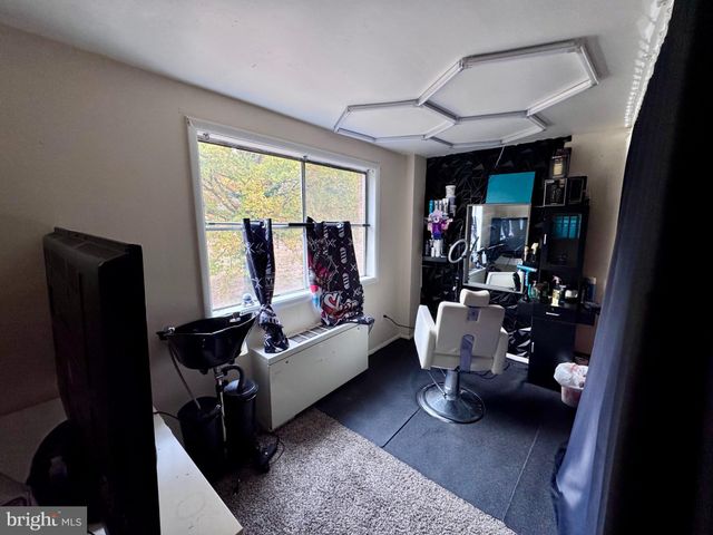 a living room with furniture rug and a window