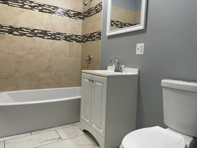 a bathroom with a toilet a sink and bathtub