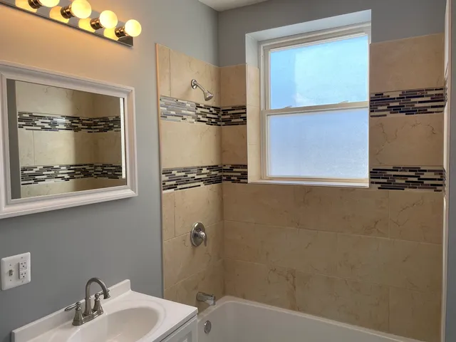 with a bathroom with a sink and mirror