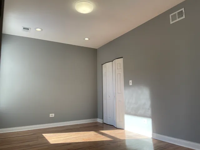 a view of entryway with a window and wooden floor