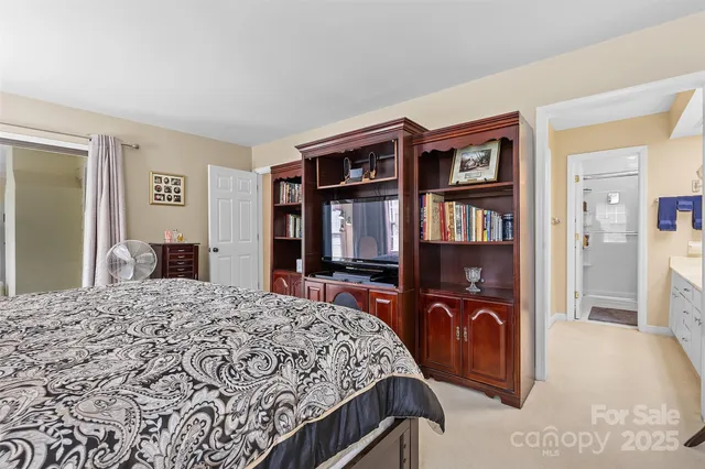 a bedroom with a bed cabinets and a dresser