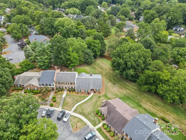 an aerial view of a house with outdoor space and a yard