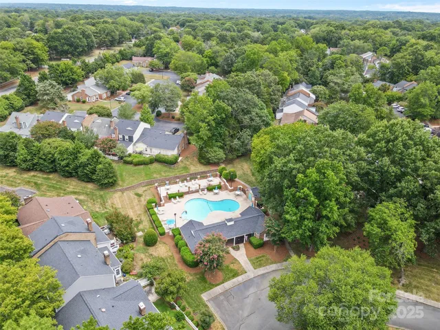 an aerial view of a residential houses with outdoor space