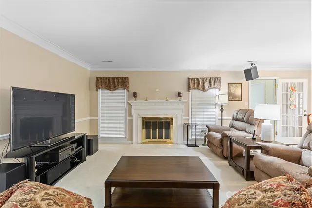 a living room with furniture flat screen tv and a fireplace
